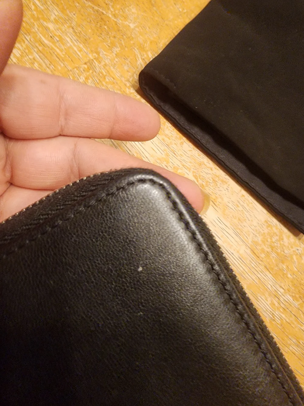 Chanel Timeless CC zip-around wallet features smooth black leather